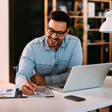 Young,Business,Man,Working,At,Home,With,Laptop,And,Papers